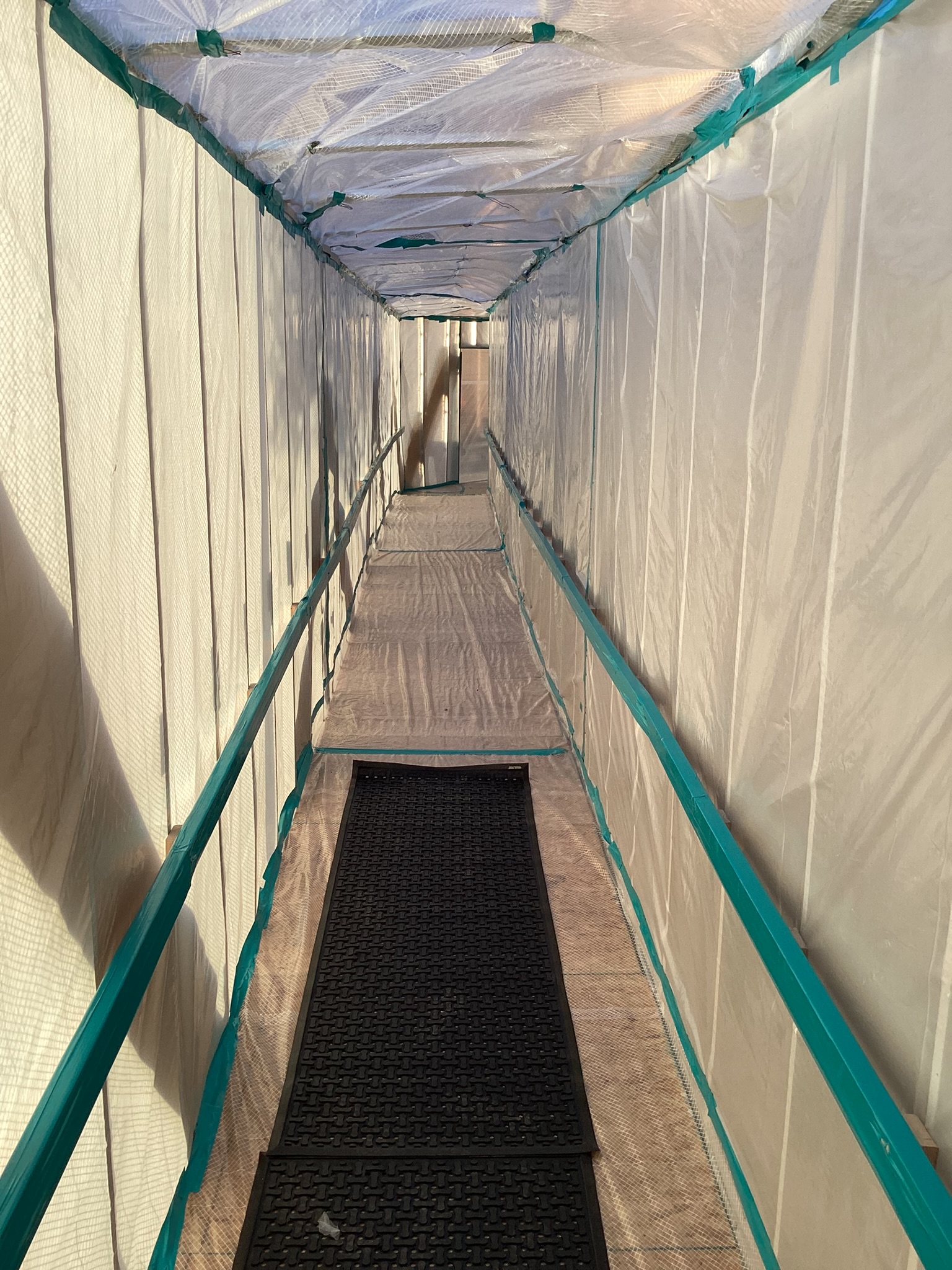 Temporary containment corridor protecting an active project area