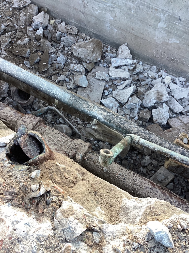 Demolition debris and exposed piping at ASU Irish, Hayden, and Best Halls