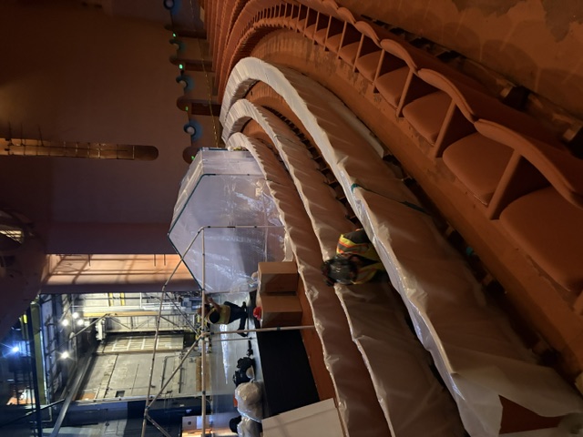 Containment structures and protected seating in the auditorium