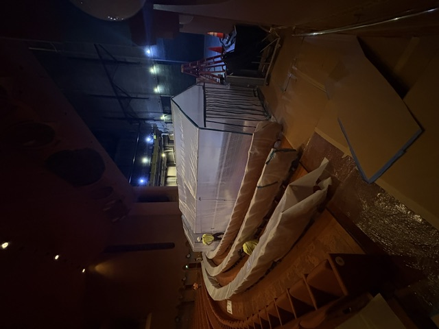Large temporary containment enclosure beside auditorium seating