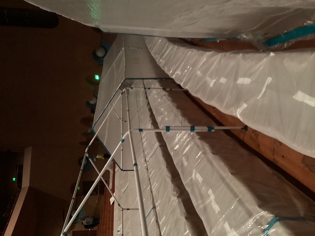 Framed containment over protected rows of seating