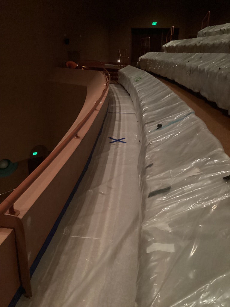 Plastic-protected auditorium seating and walkway containment