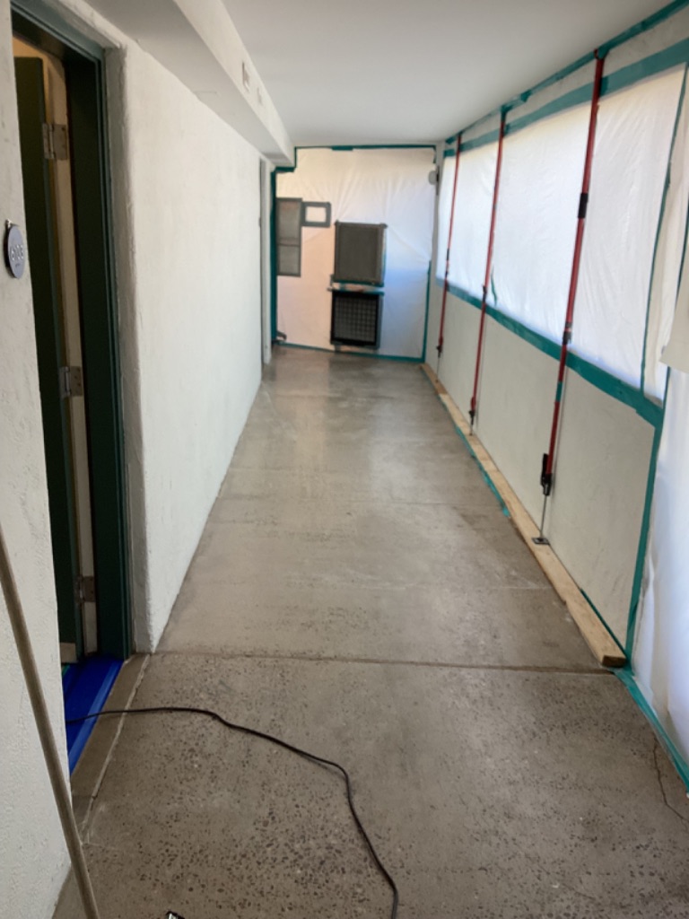 Protected hotel corridor with temporary barriers and filtration
