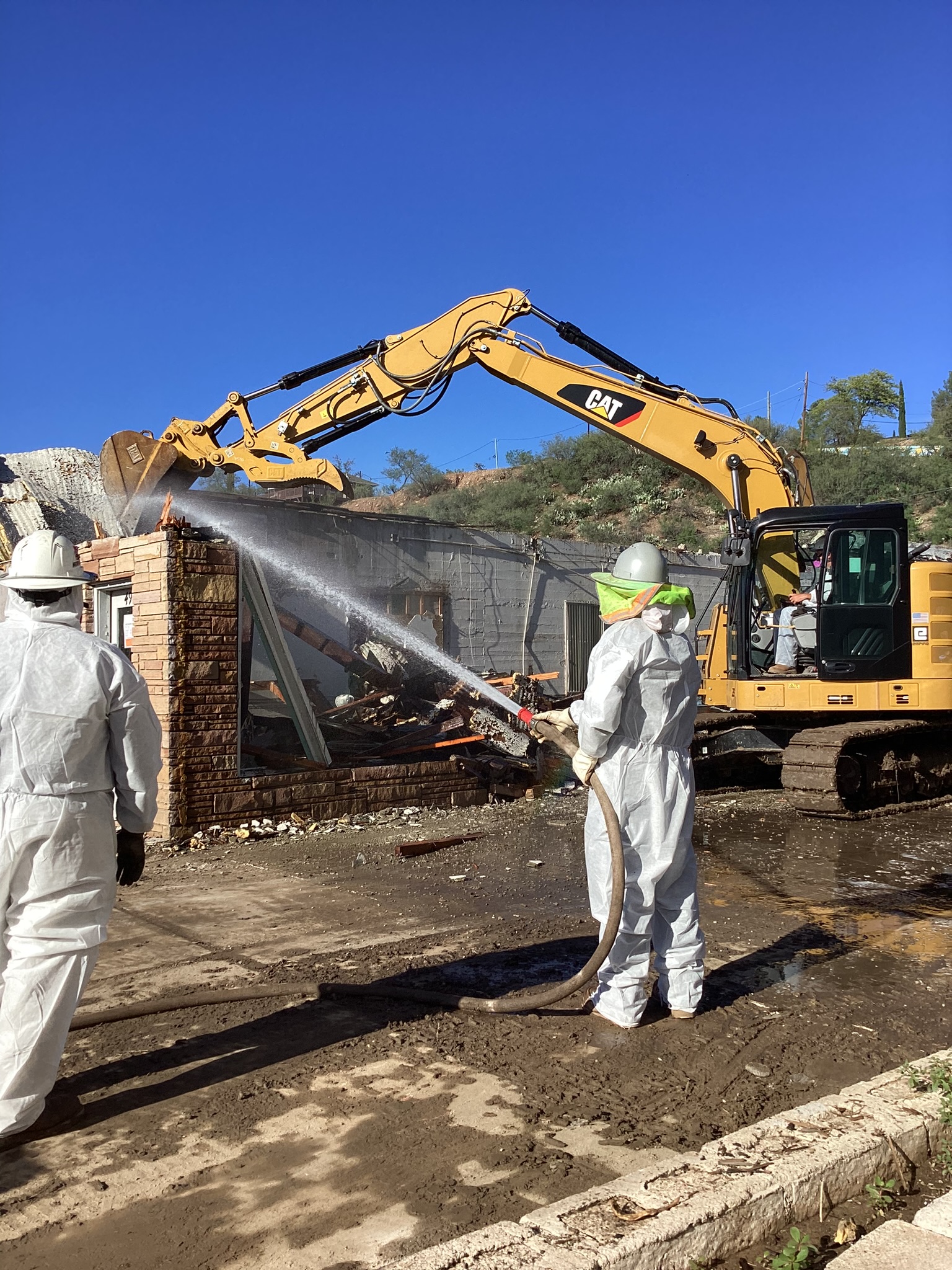 Viking crew using wet suppression during controlled exterior demolition