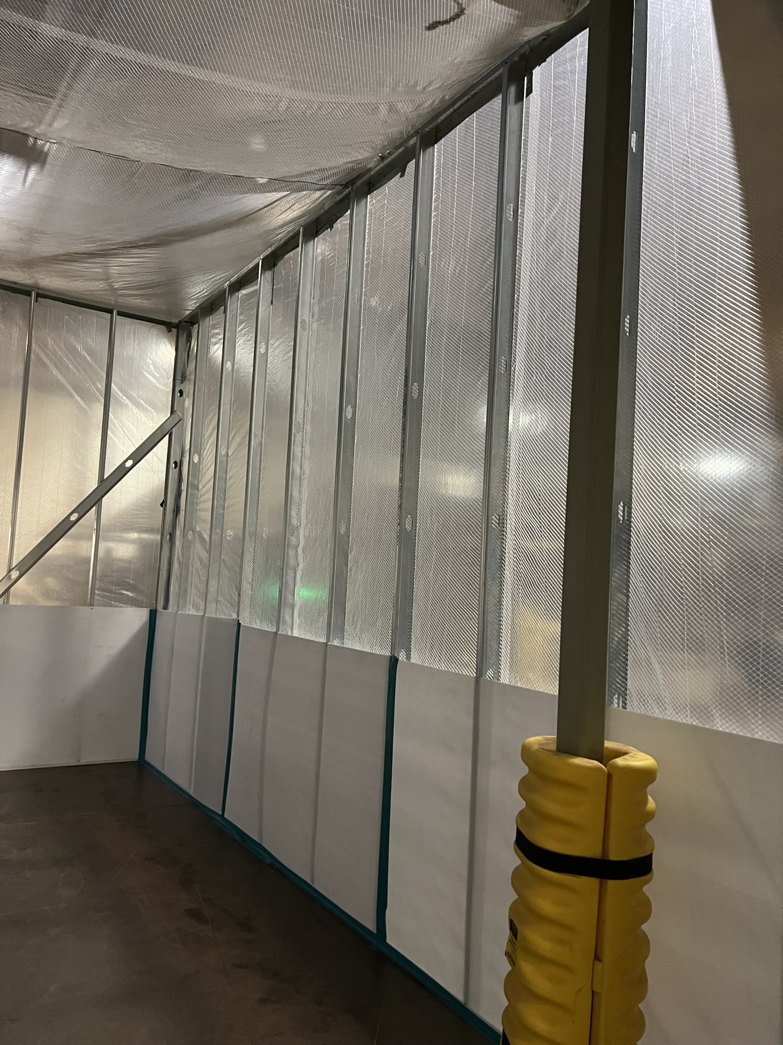 Framed containment enclosure inside an active facility