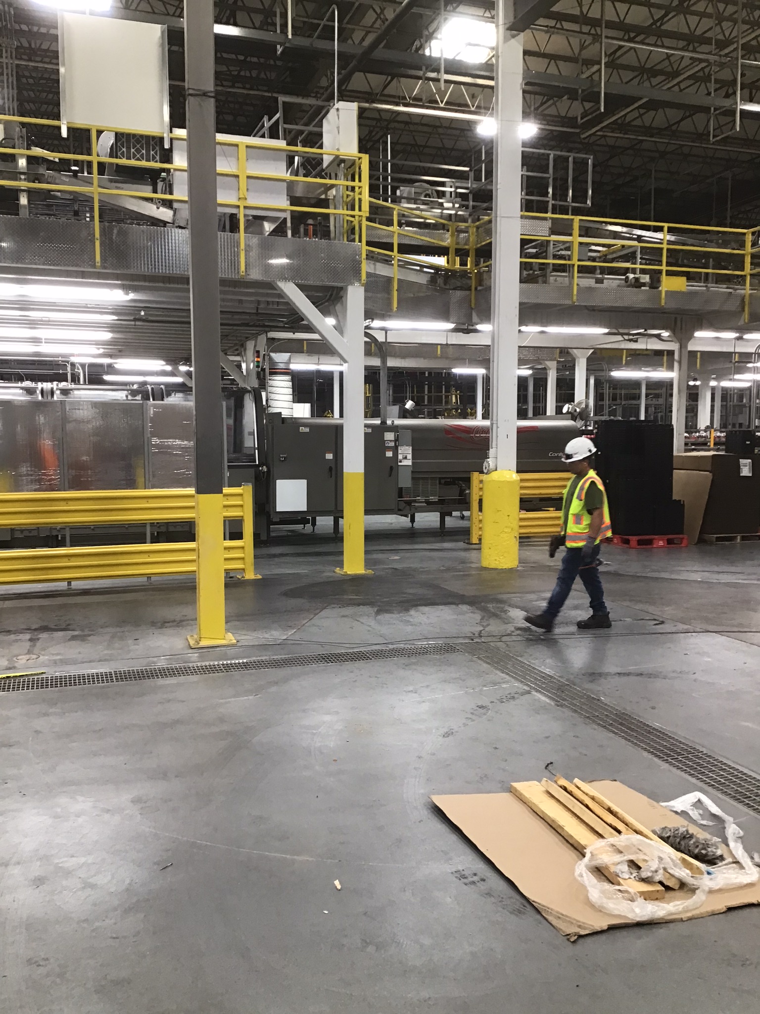 Industrial facility work area with equipment, containment, and protected access routes