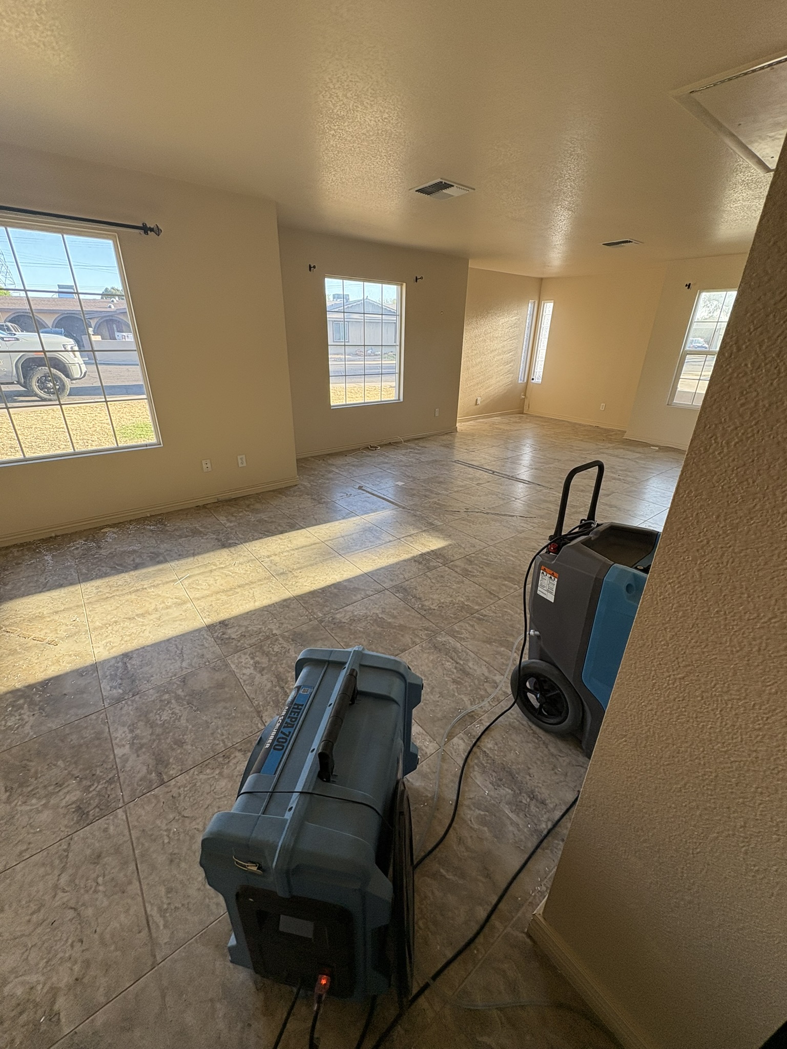Interior floor cleaning and air-scrubbing equipment in a work area
