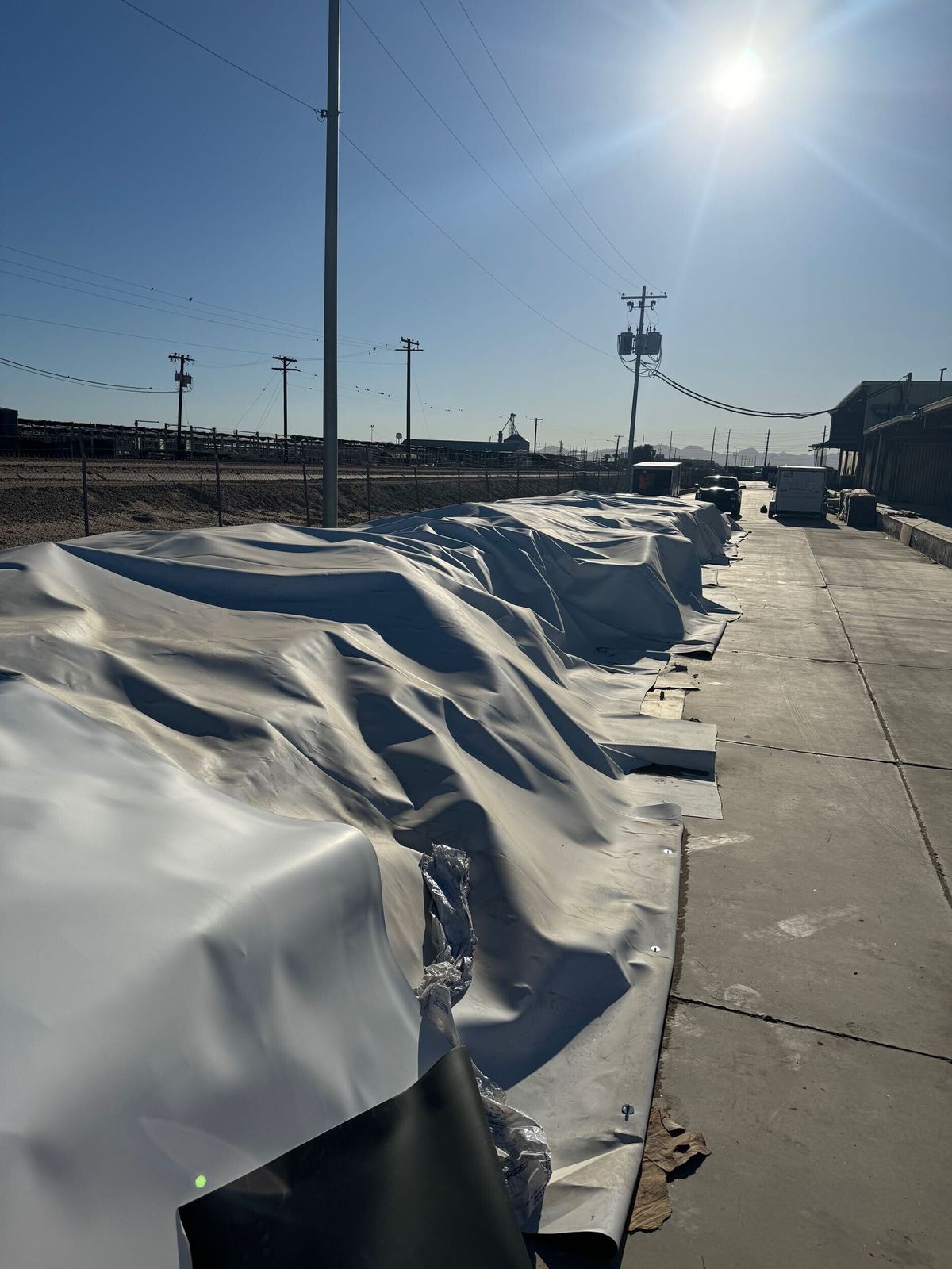 Covered exterior material staged for regulated handling.