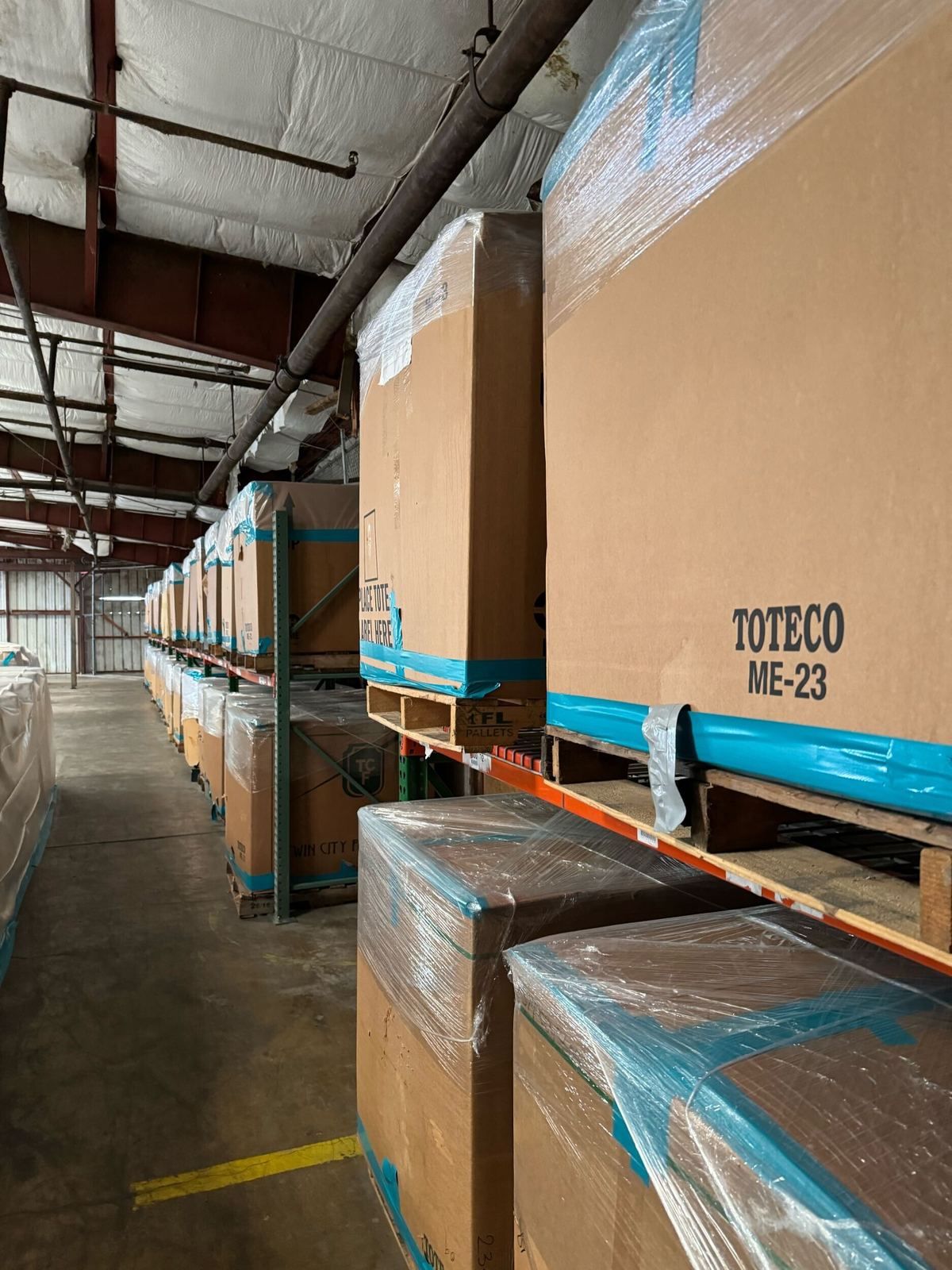 Palletized food bank inventory protected during environmental work.