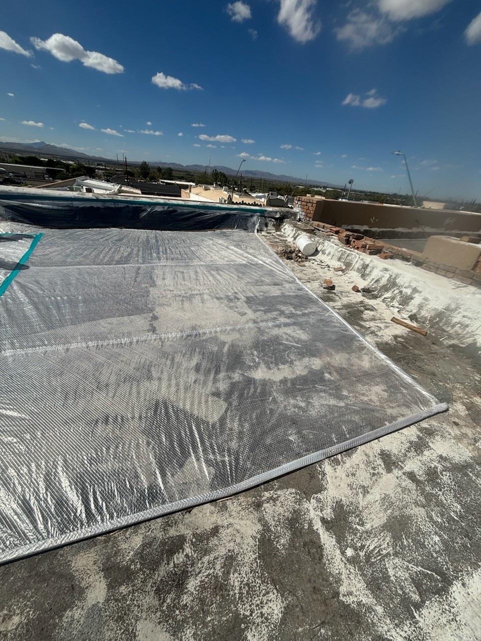 Rooftop containment and dust-control protection on an Arizona commercial project